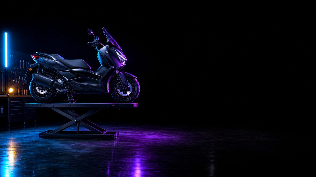 Motorcycle raised on the hydraulic workshop lift at Motoko Autohub